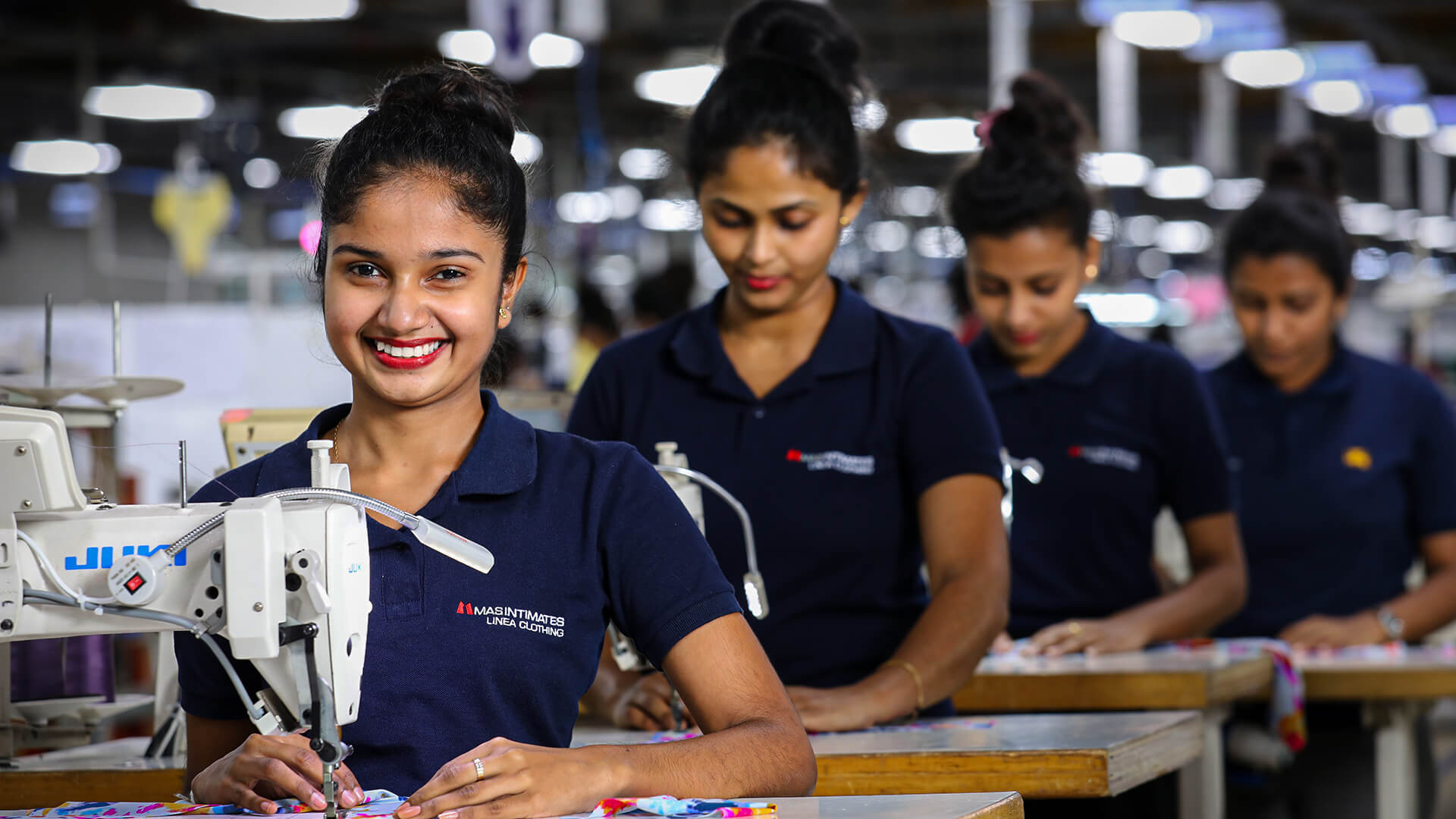 Girls working on stitching machine